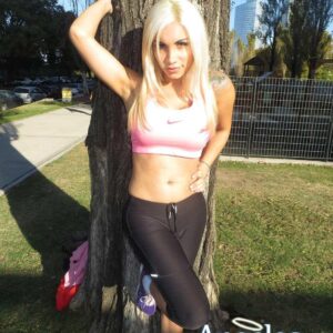 Sporty blonde shemale Angeles Cid freeing sexy ass from spandex pants in public