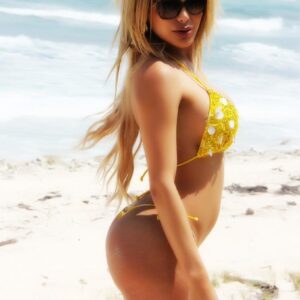 Blonde TS pornstar Karla Carrillo freeing big cock and phat ass from bikini on beach