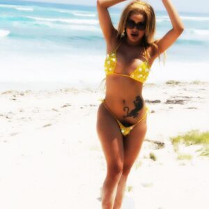 TS pornstar Karla Carrillo letting big dick loose from bikini on beach in sunglasses