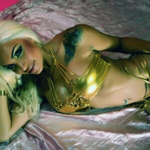 Platinum blonde shemale Angeles Cid models a gold bikini during a non naked solo shoot