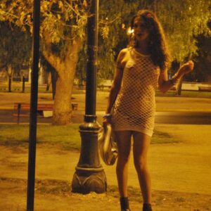 Tgirl prostitute Nikki Montero stands naked on a street