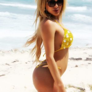 Blonde TS pornstar Karla Carrillo frees her big tits from a bikini on beach