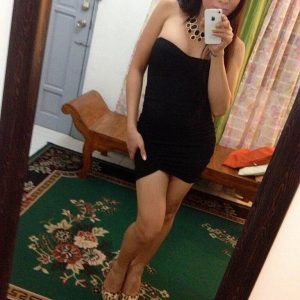 Cute brown-haired ladyboy Vitress Tamayo takes self shots in a mirror