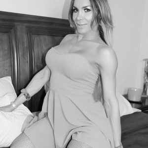 Tall trans girl  Nelly Ochoa bares her big boobs in pantyhose and heels upon a bed
