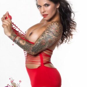 Tattooed trans model Foxxy takes off revealing clothing while getting naked in heels