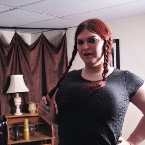 Redheaded tranny Tiffany Starr inserts an anal dildo with her hair in braided pigtails