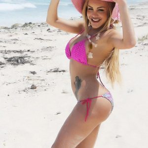 Beautiful blonde shemale Karla Carrillo unleashes her big boobs at the beach