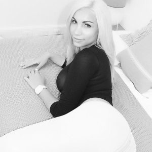 Beautiful ash-blonde trans model Angeles Cid extracts her big cock from yoga pants